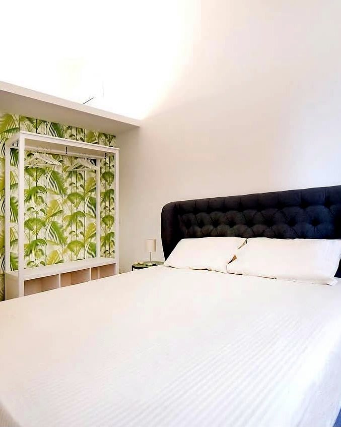 Vatican Apartment — bedroom with palm leaf wallpaper